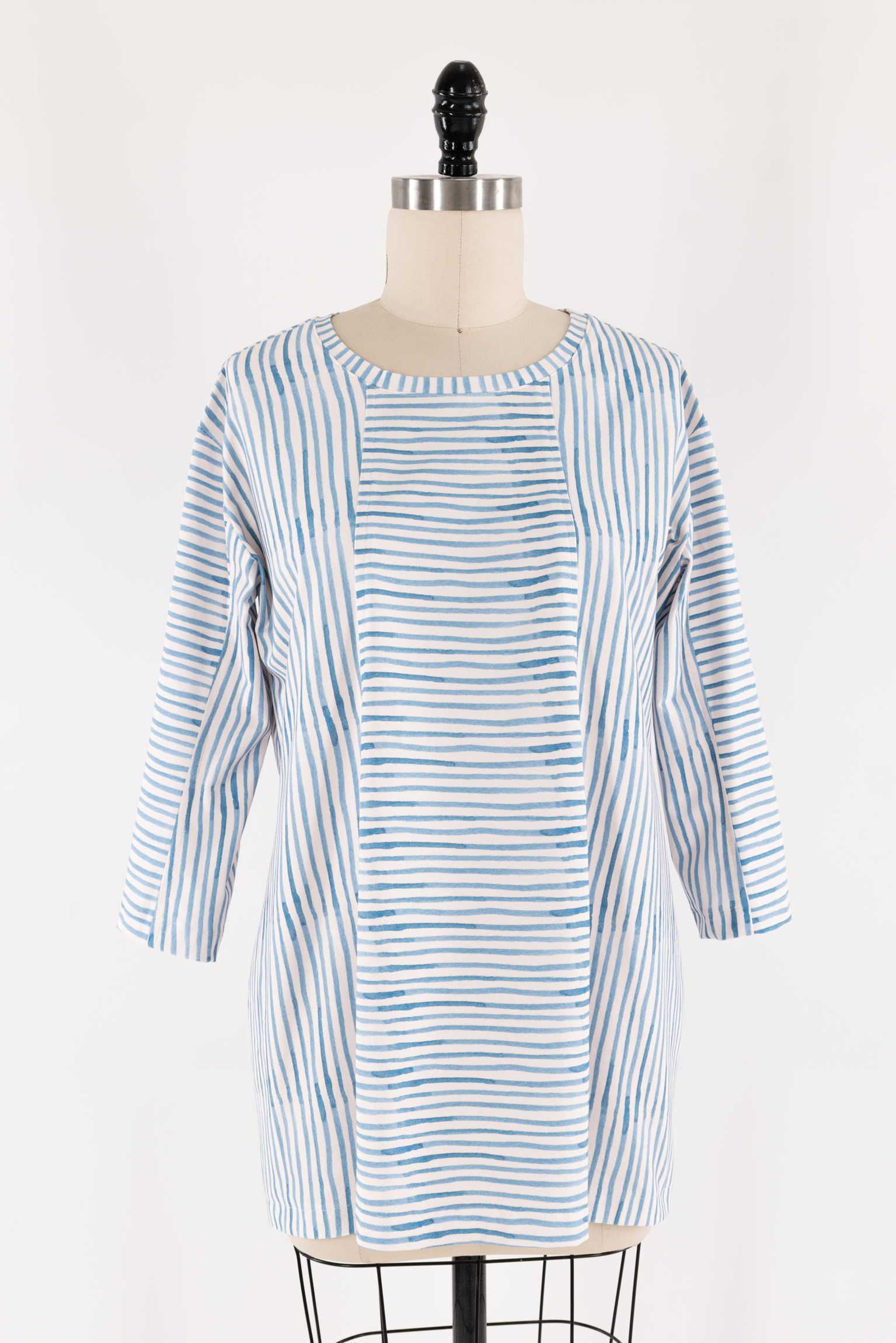Blue and white striped tunic dress on mannequin, ideal for sewing projects with cotton or linen fabric