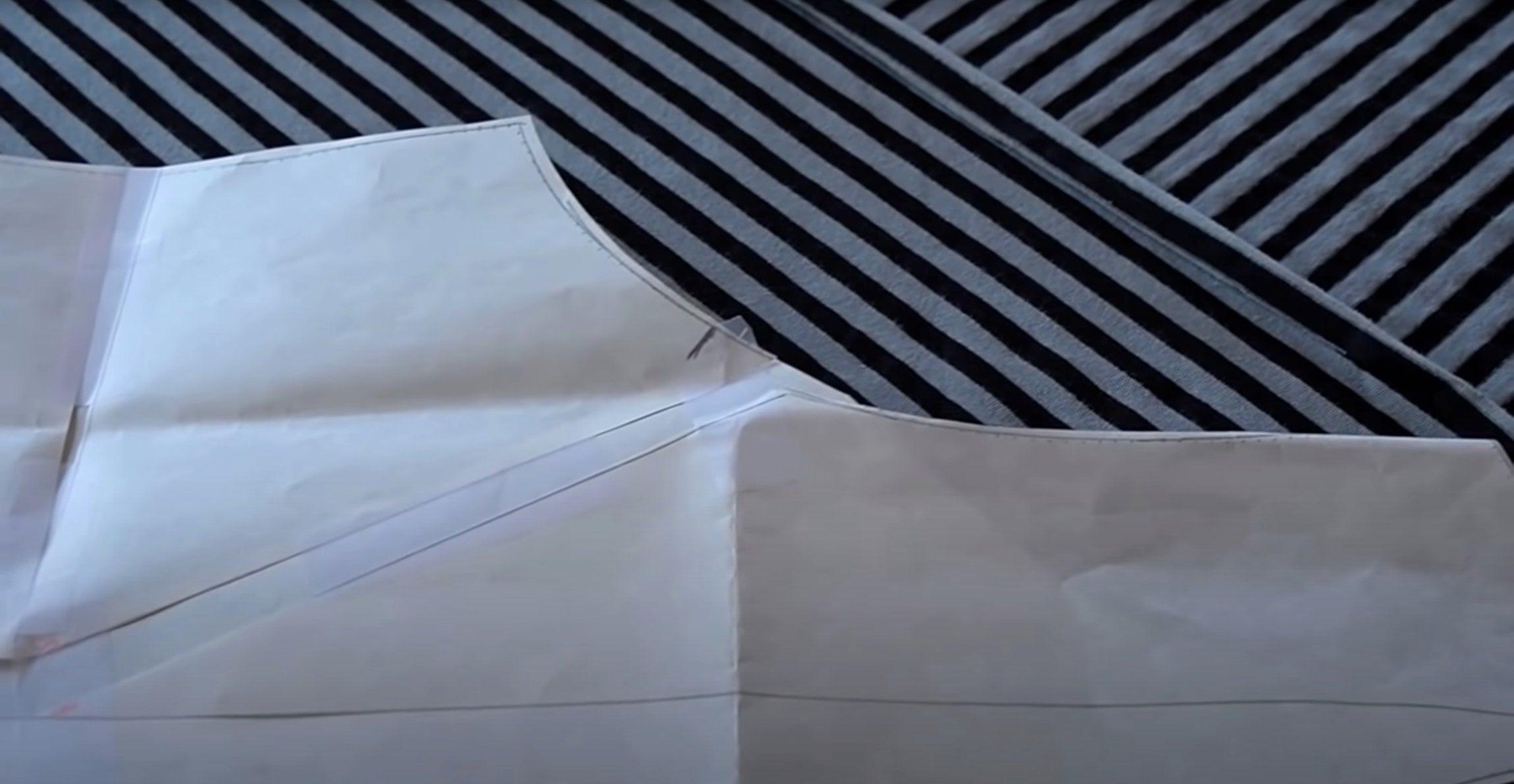 Black and white striped fabric with sewing pattern overlay for apparel design