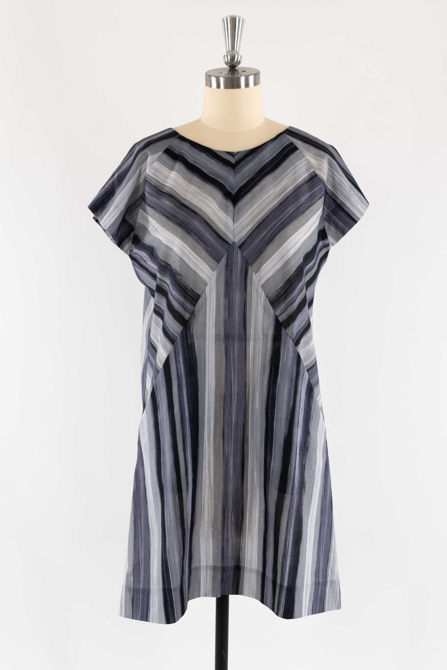 Gray and black striped dress with chevron pattern, short sleeves, displayed on mannequin