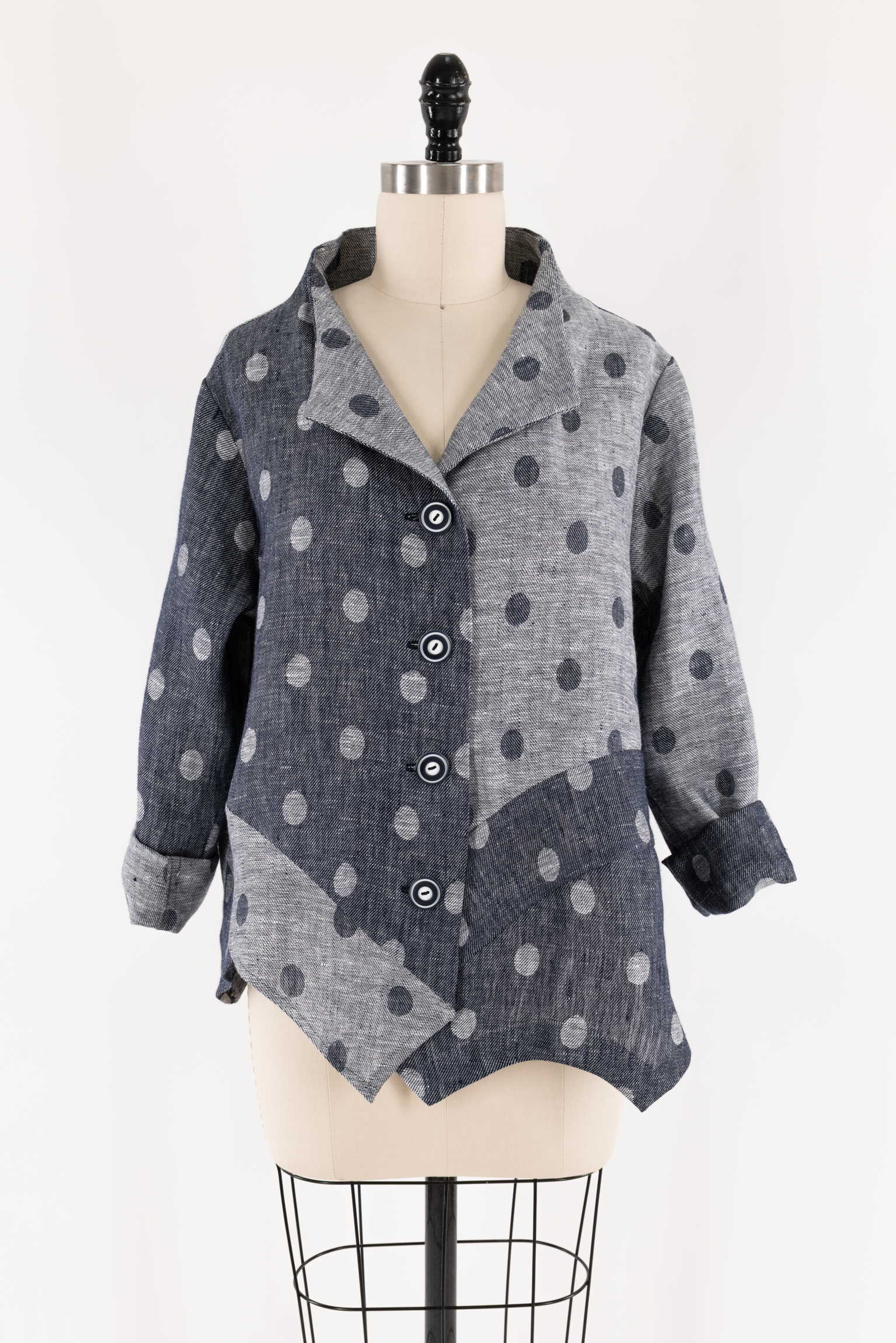 Gray and navy polka dot button-up jacket on mannequin, ideal for sewing apparel and creative fashion projects.
