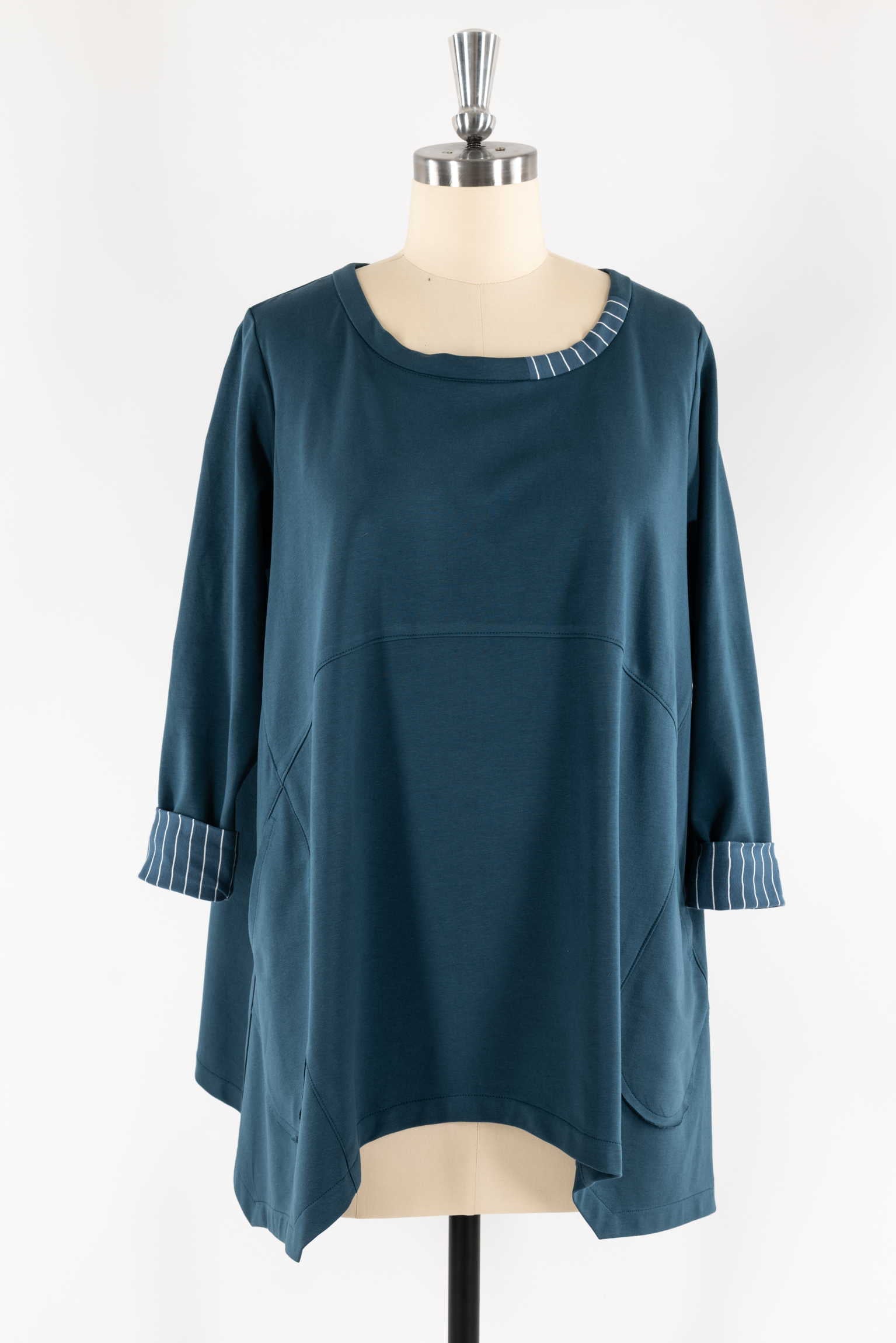 Teal tunic with striped cuffs and neckline, displayed on mannequin for sewing projects