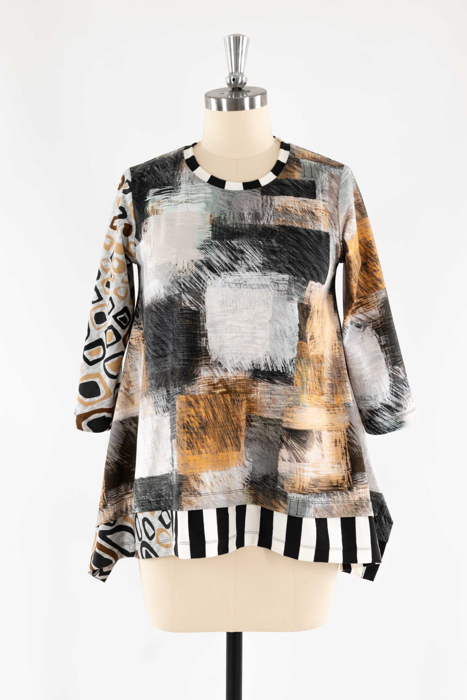 Abstract print tunic with black white stripes, geometric patterns, and 3/4 sleeves on mannequin
