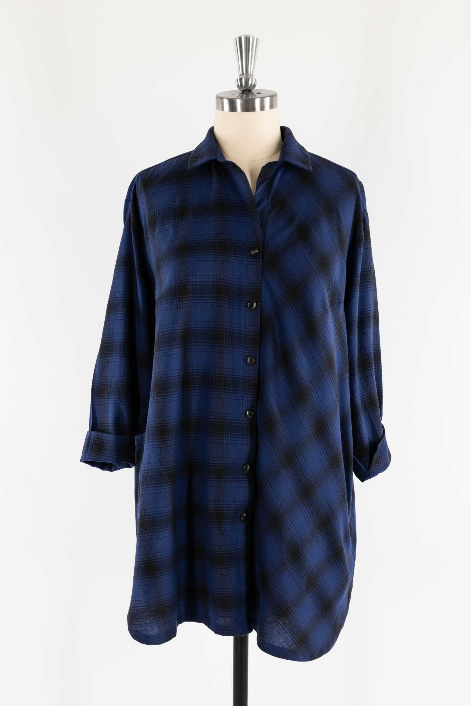 Blue and black plaid button-up shirt dress on mannequin, ideal for sewing apparel projects
