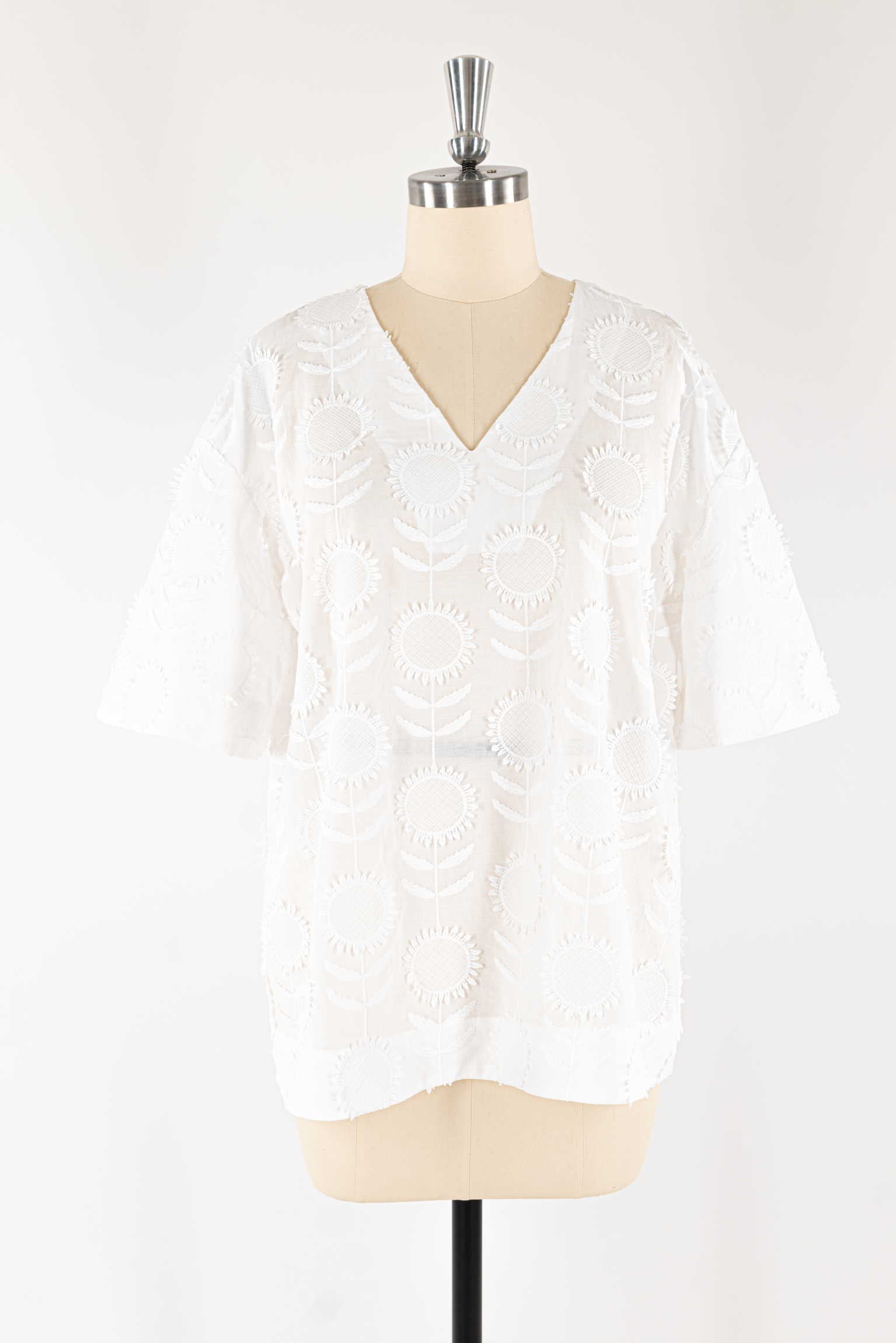 White embroidered sunflower tunic top with V-neck and short sleeves, ideal for sewing apparel projects