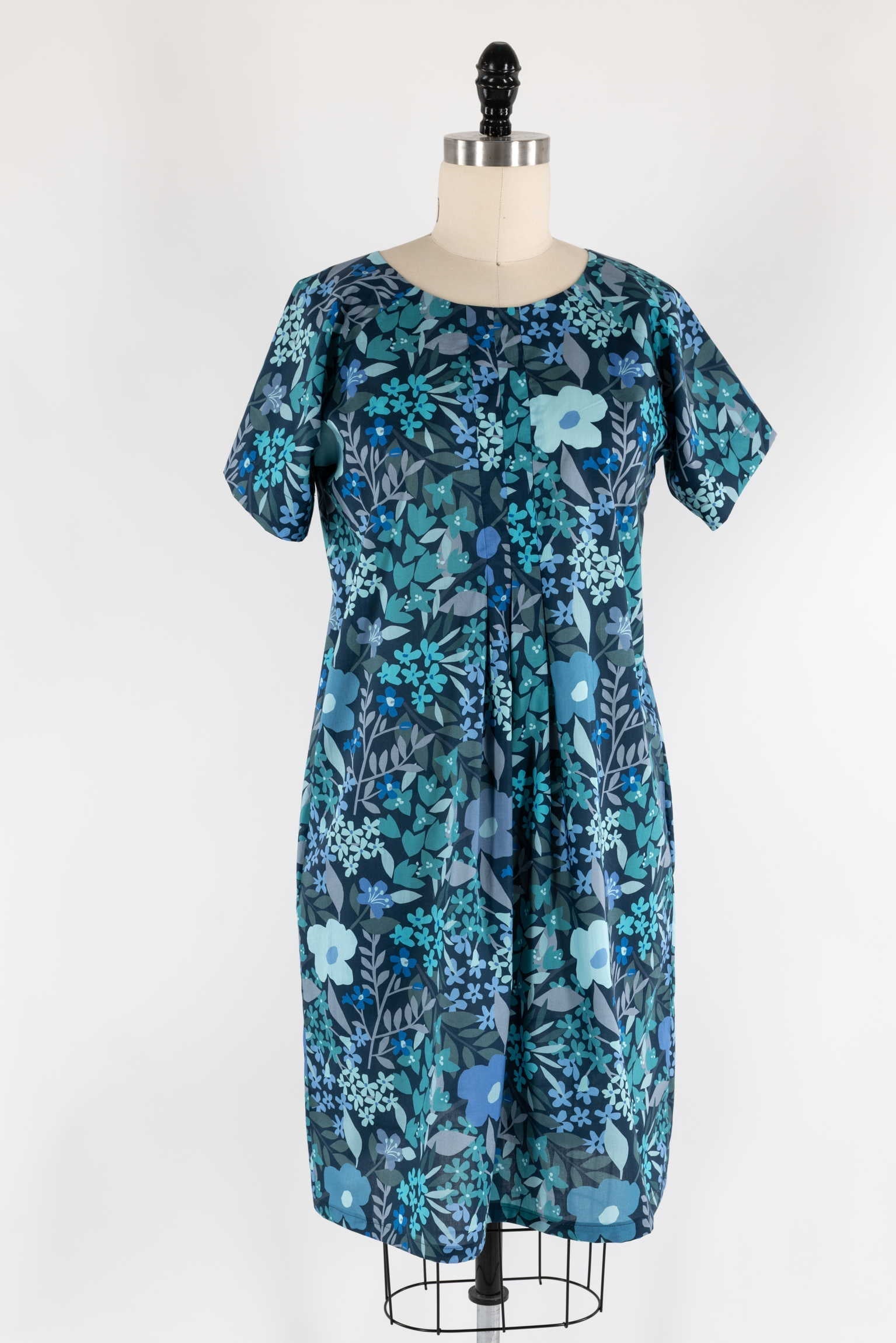 Blue floral print dress on mannequin, ideal for sewing apparel with cotton or rayon fabric