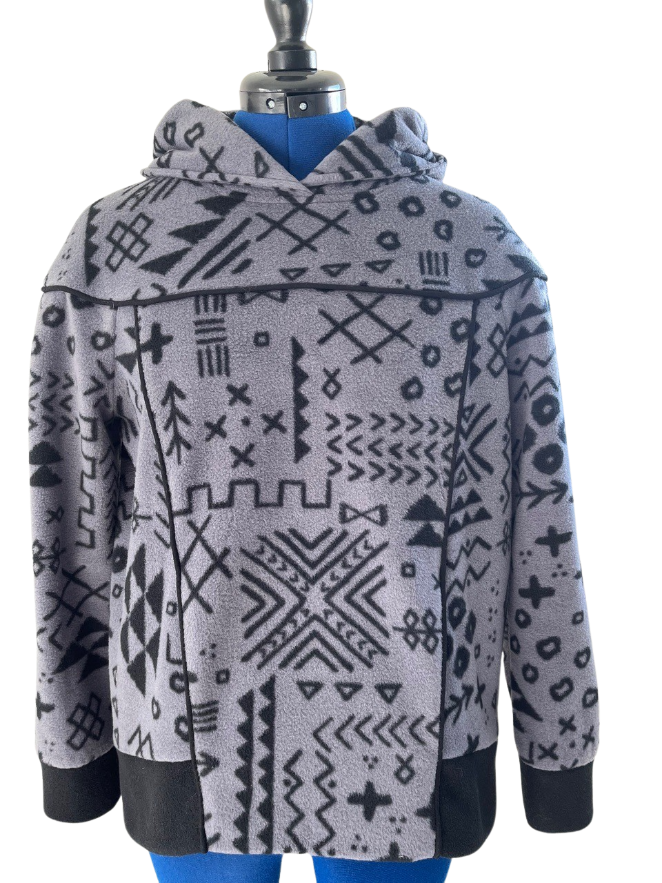 Gray hoodie with black geometric tribal print, featuring hood, long sleeves, and contrast cuffs — ideal for apparel sewing projects.