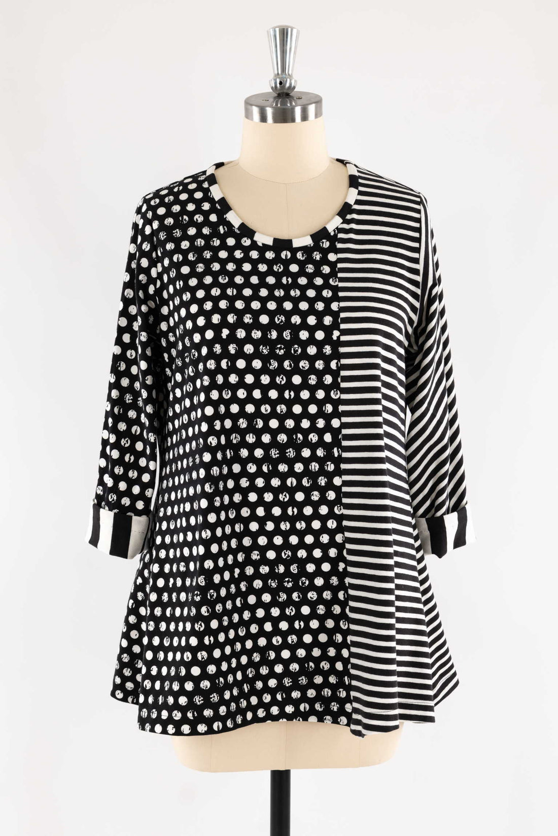 Black and white polka dot and stripe patterned tunic top on mannequin, ideal for sewing apparel