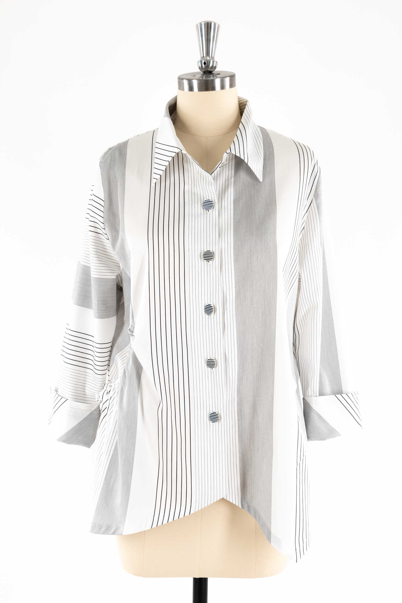 White and black striped button-up shirt with long sleeves on mannequin, ideal for sewing apparel