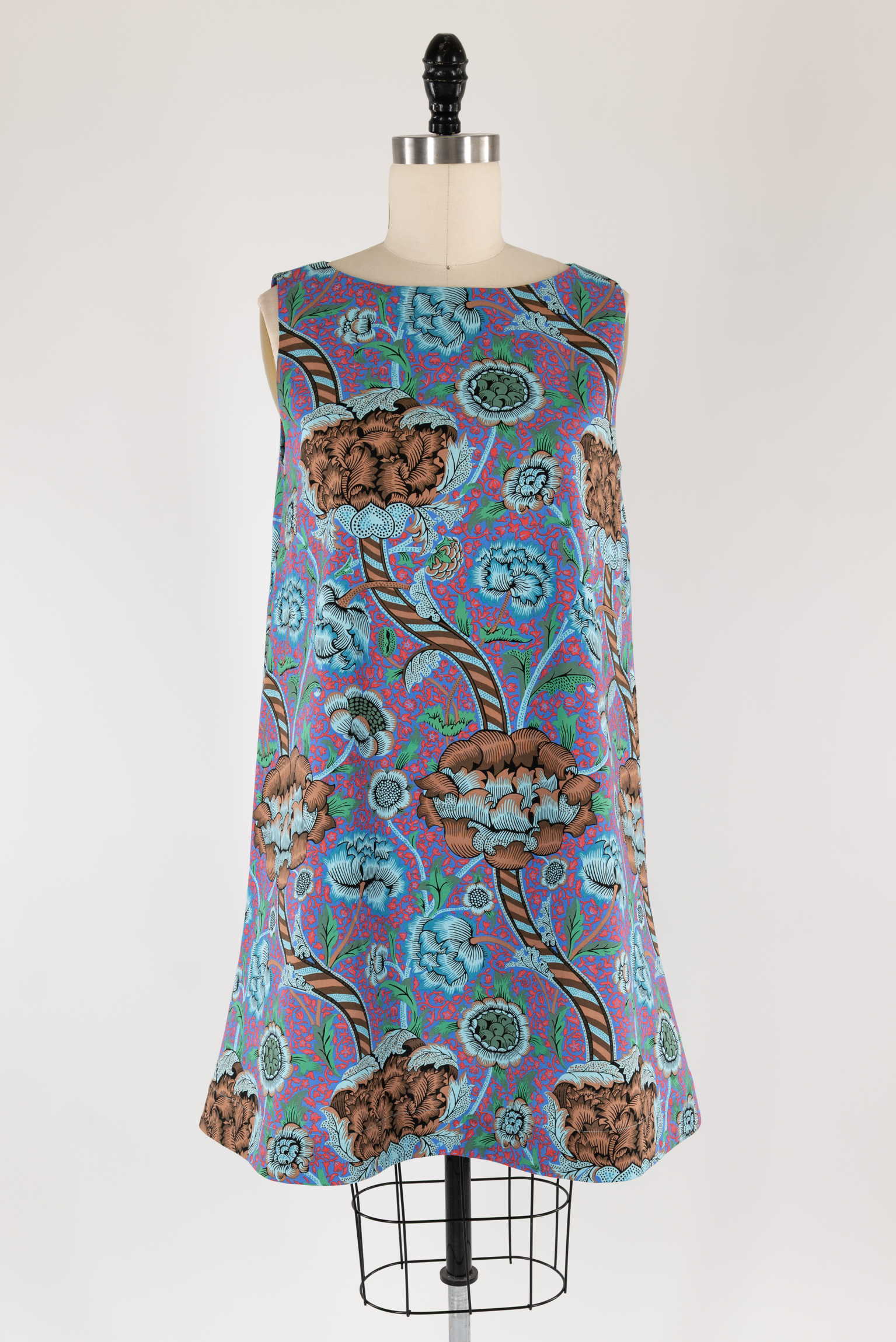 Vibrant floral dress with blue, red, and brown patterns on a mannequin